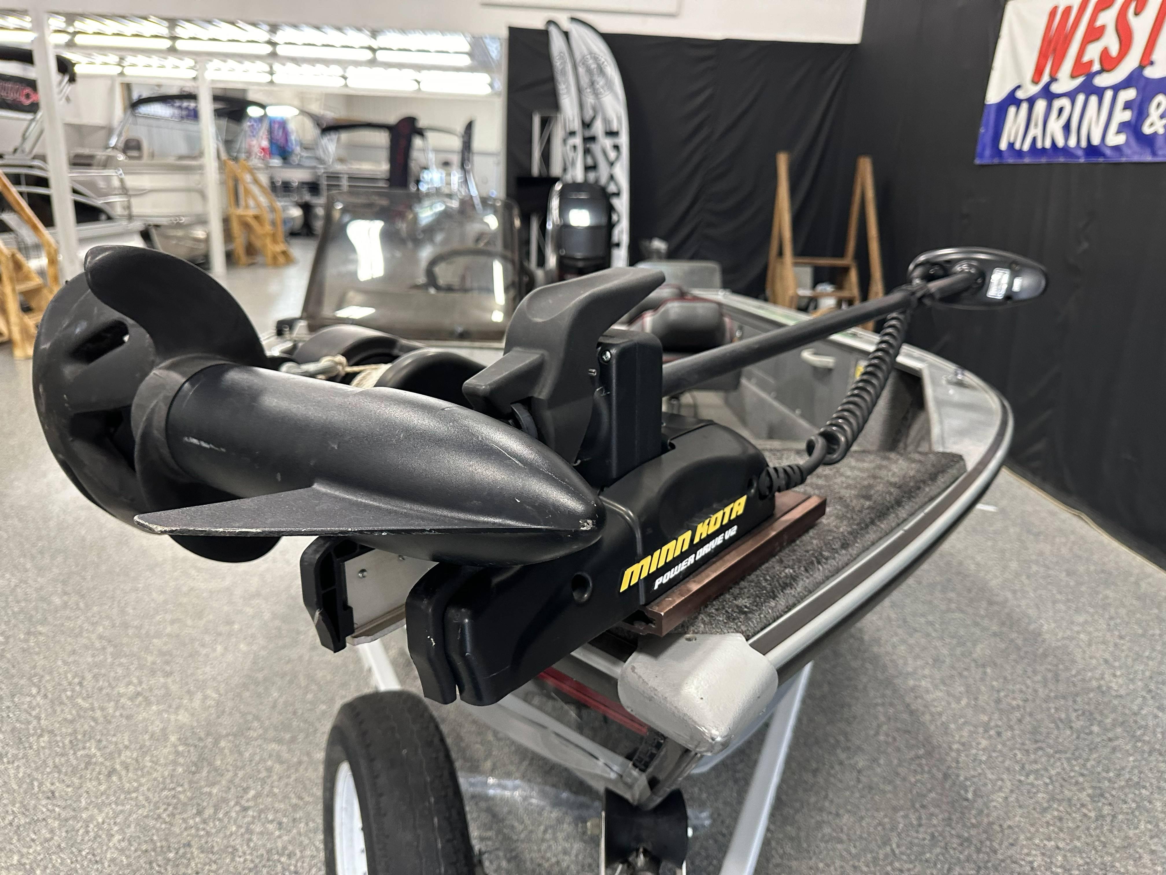 1995 Lund 1650 DLX boat with Minn Kota trolling motor in showroom.
