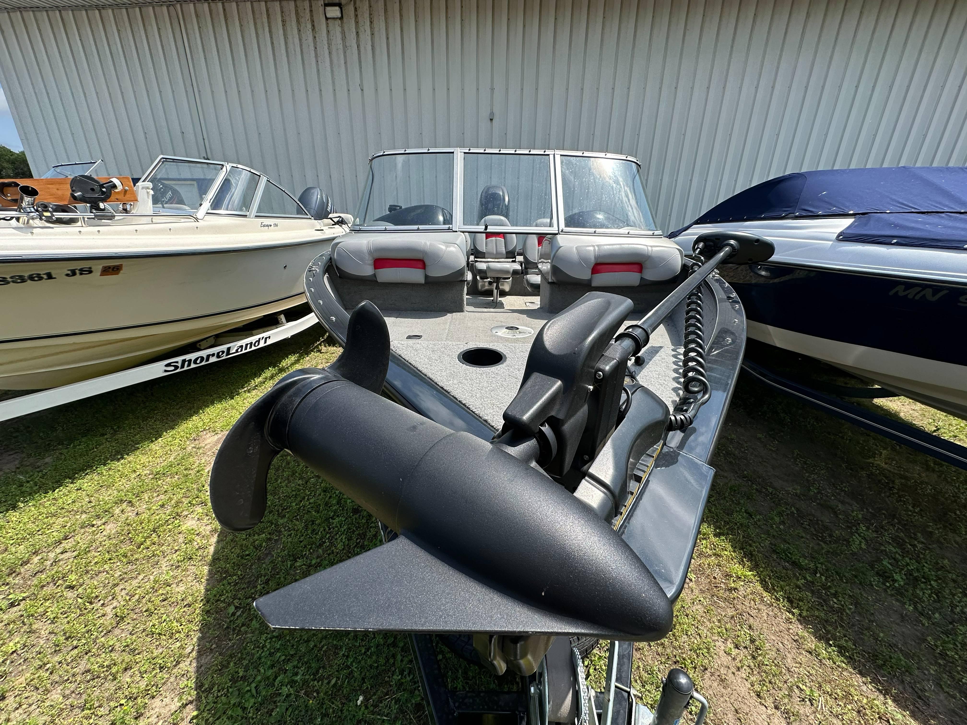 2013 Tracker Pro Guide V-175 WT boat with trolling motor, parked outdoors.