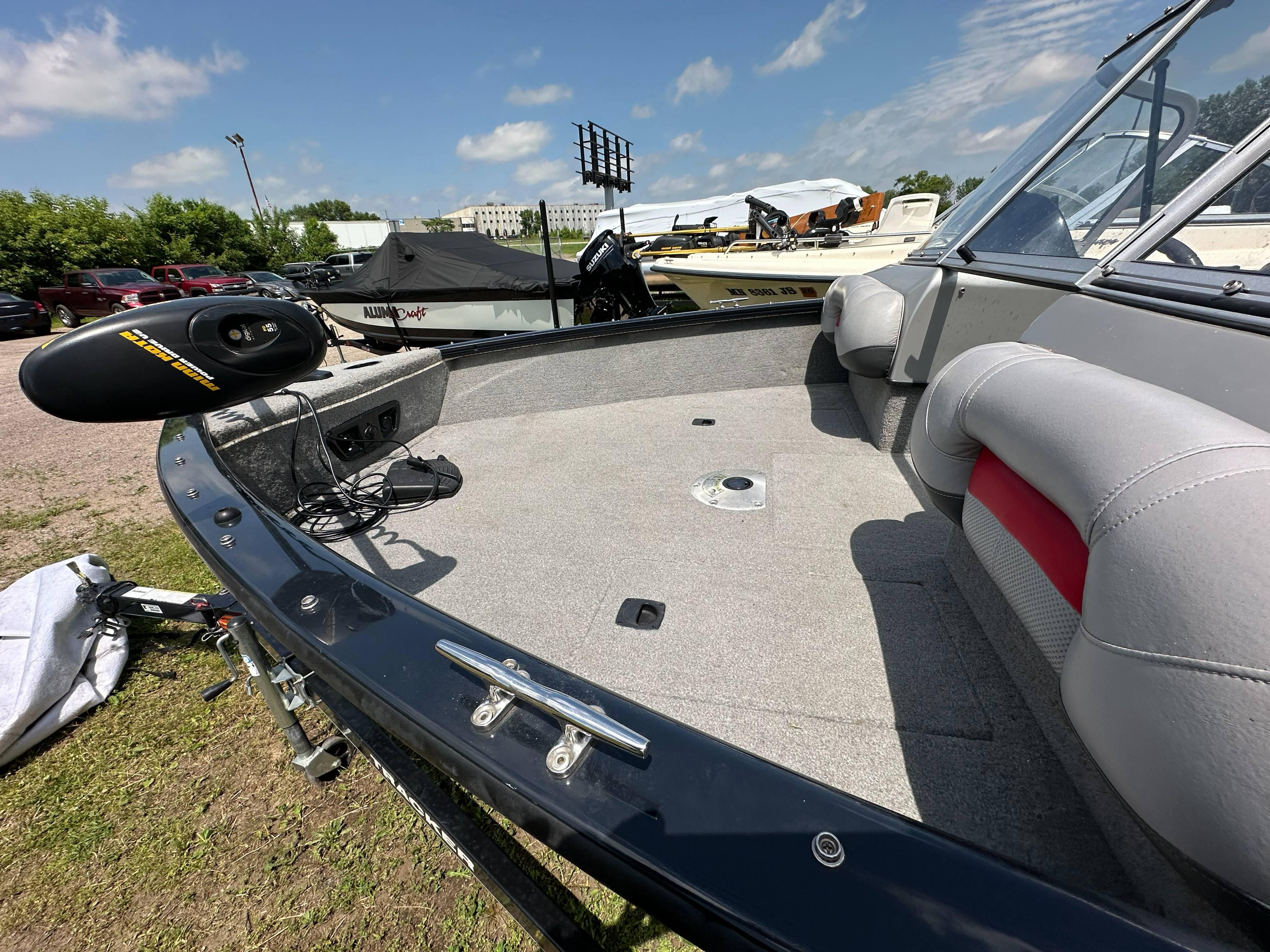 2013 Tracker Pro Guide V-175 WT boat interior with seating and equipment, parked outdoors.
