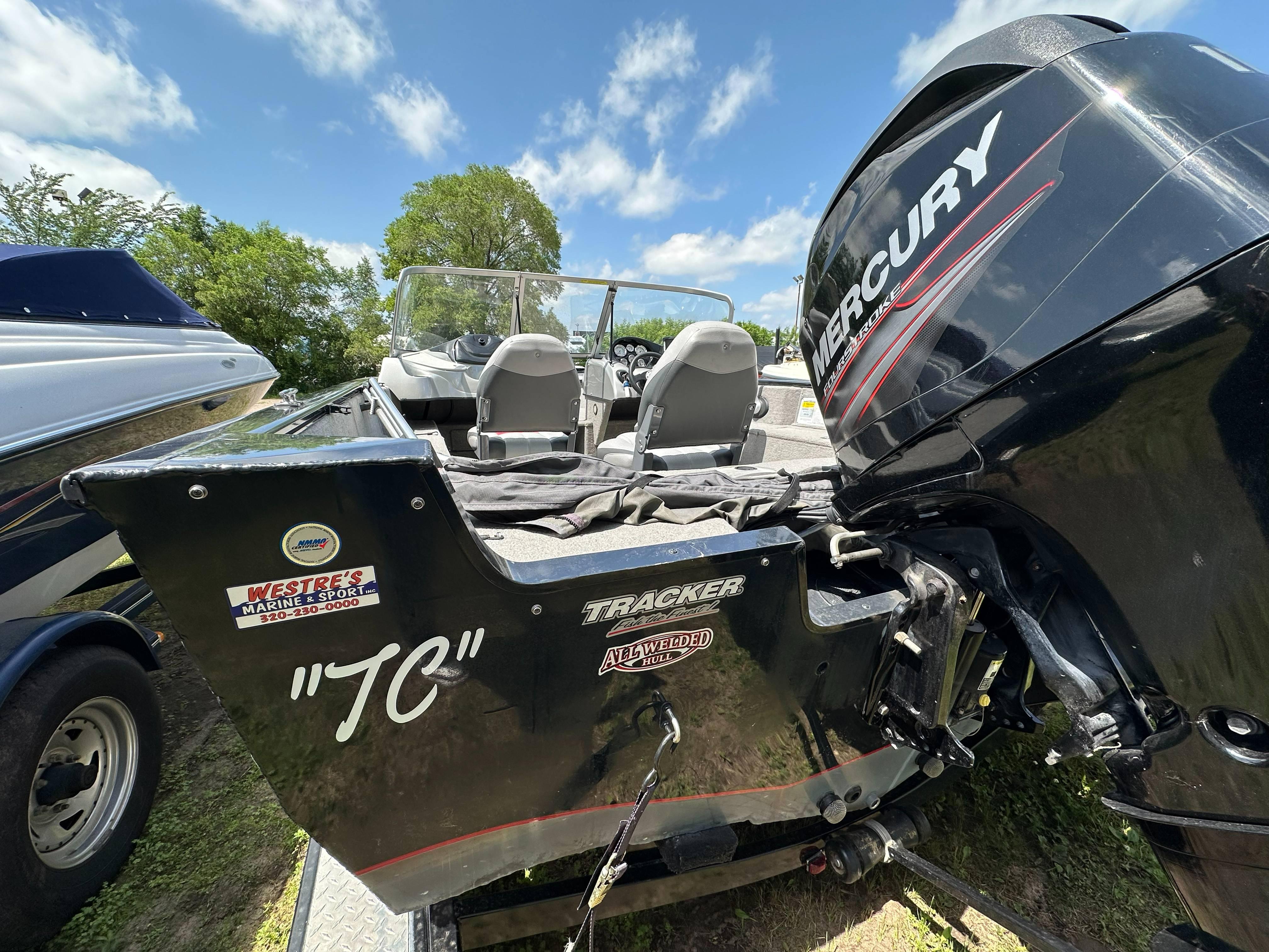 2013 Tracker Pro Guide V-175 WT boat with Mercury engine, parked outdoors.