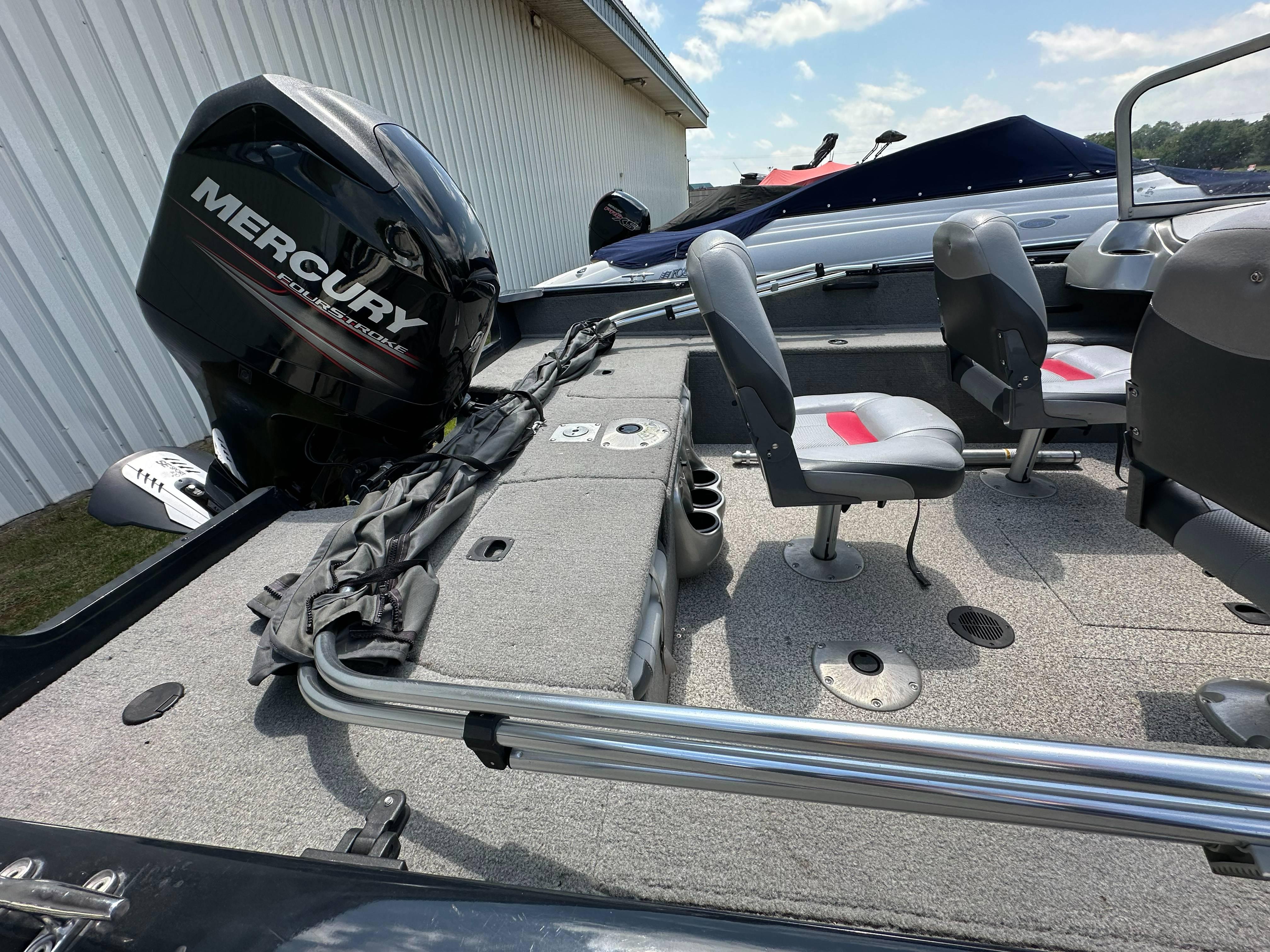 2013 Tracker Pro Guide V-175 WT boat interior with Mercury engine, featuring seating and storage.