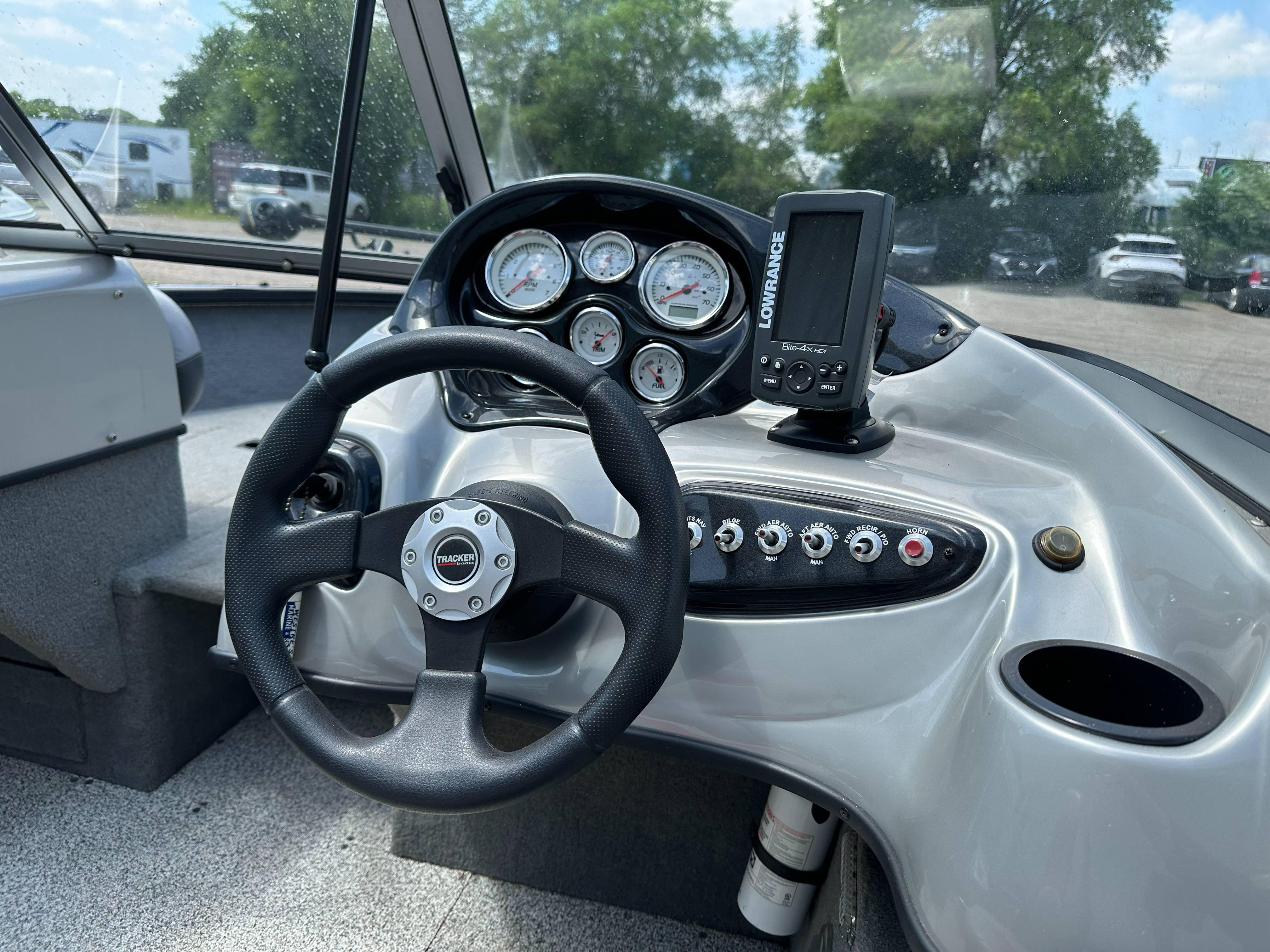 2013 Tracker Pro Guide V-175 WT boat dashboard with steering wheel and gauges.