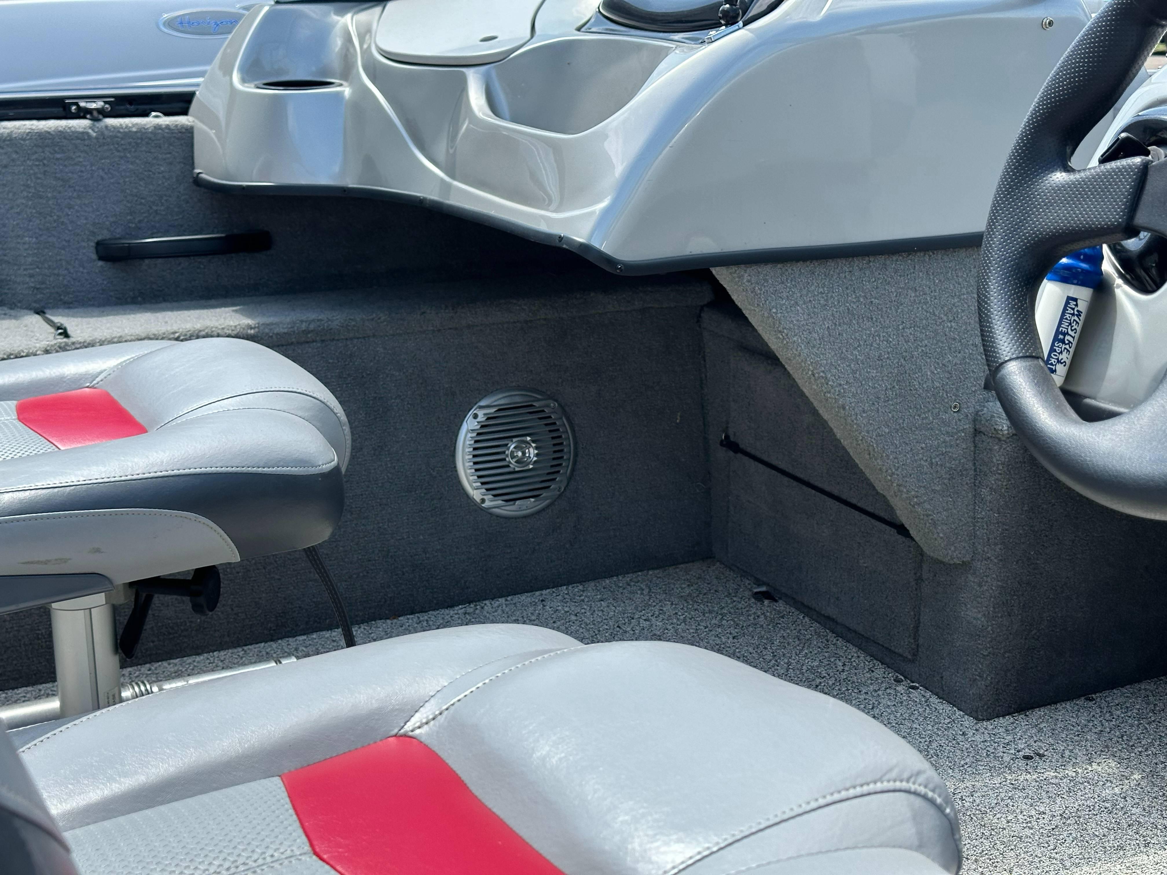 2013 Tracker Pro Guide V-175 WT boat interior with gray and red seating.