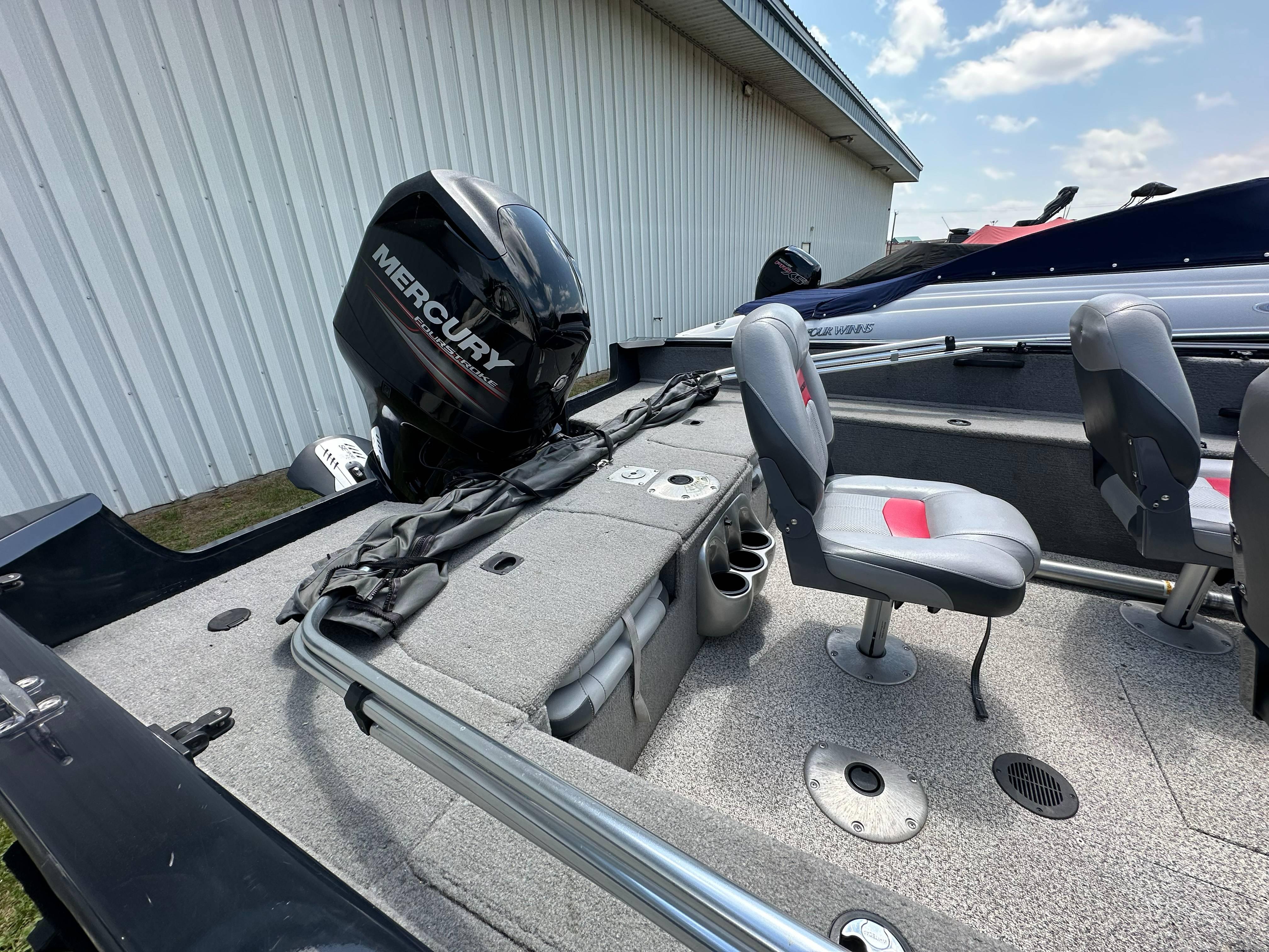 2013 Tracker Pro Guide V-175 WT boat with Mercury outboard motor, gray interior, and seating.