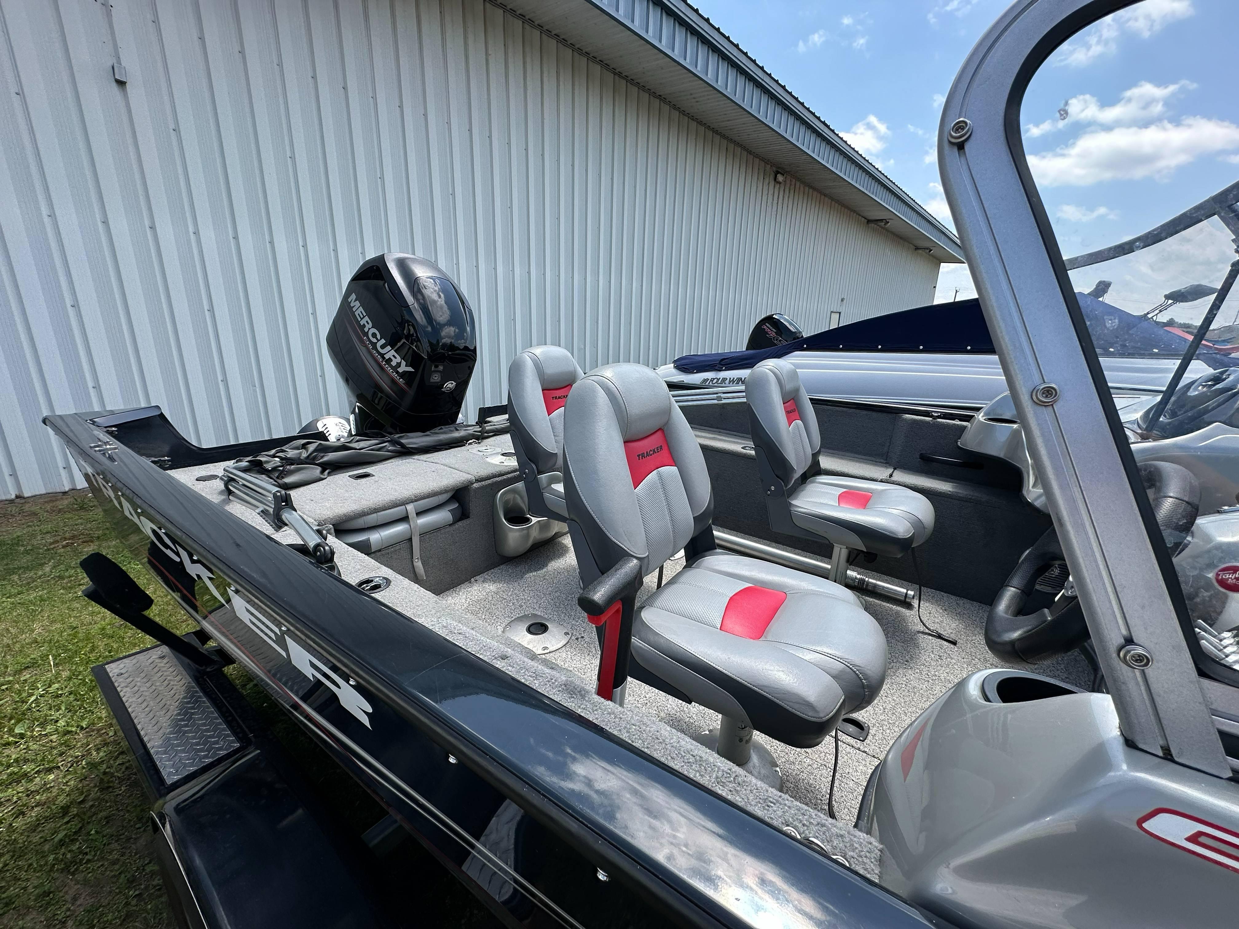 2013 Tracker Pro Guide V-175 WT boat with Mercury engine, gray and red seating.