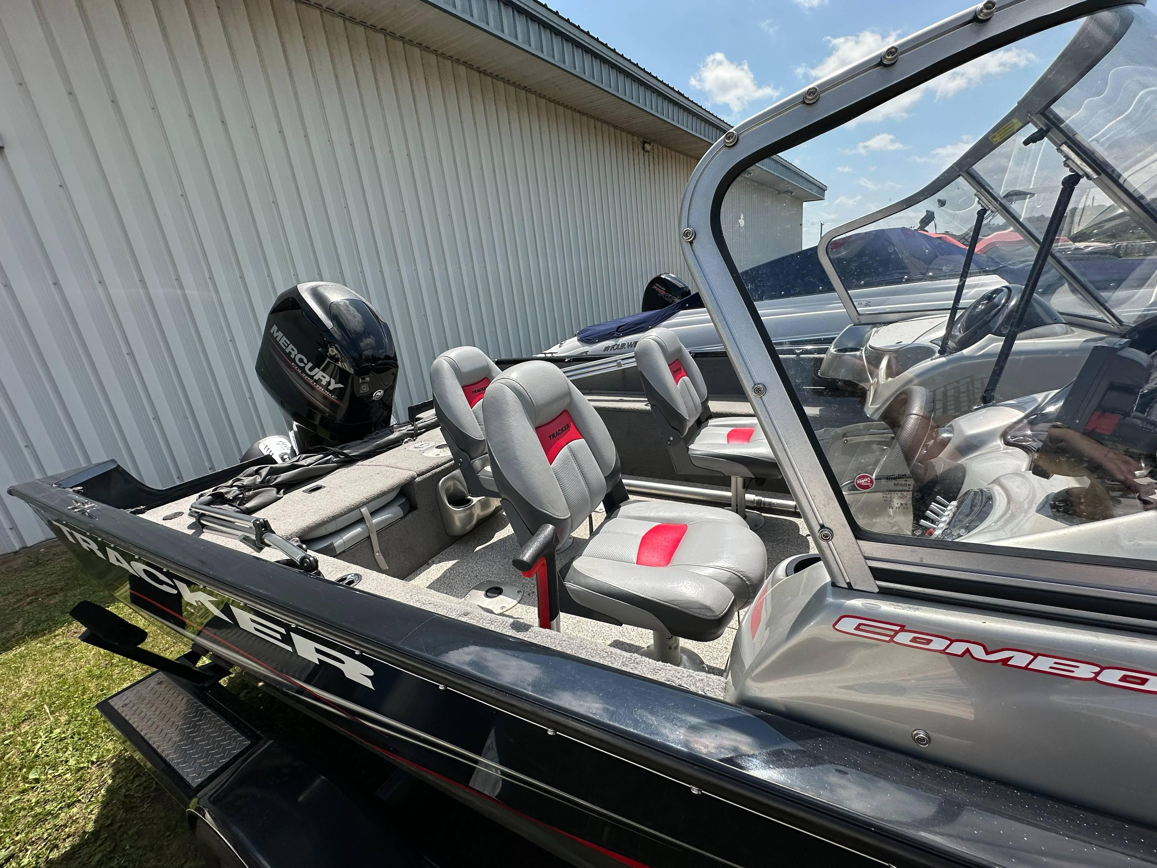 2013 Tracker Pro Guide V-175 WT boat with Mercury engine, featuring red and gray seating.