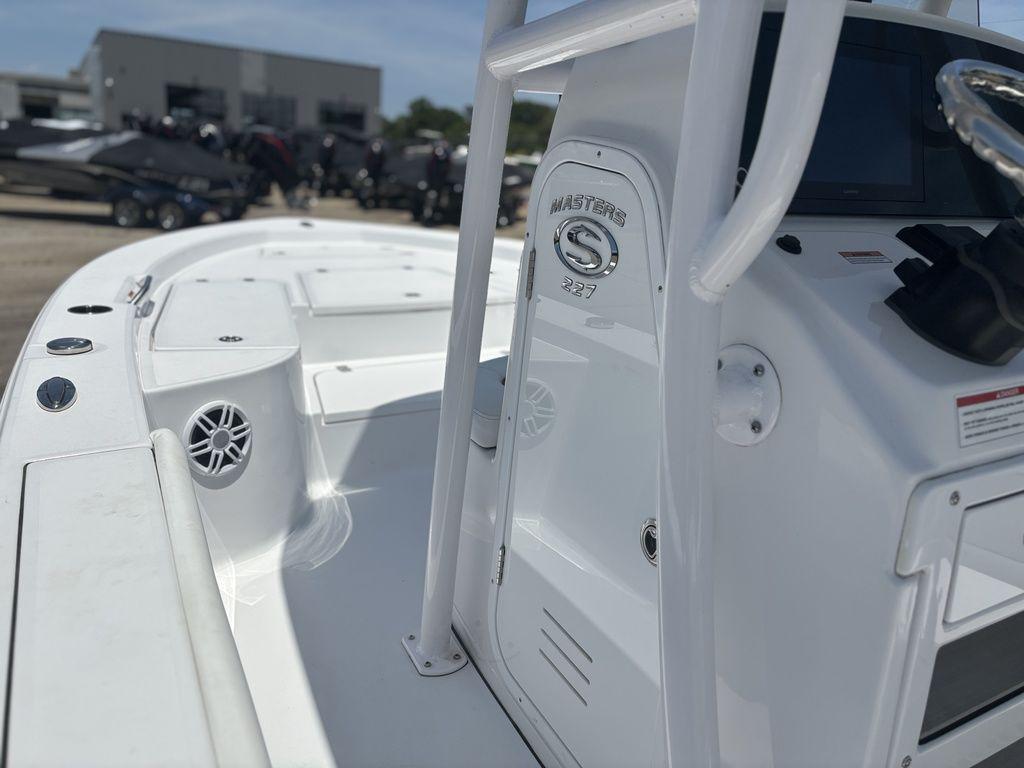 2024 Sportsman Masters 227 Bay boat, white interior, console view, outdoor setting.