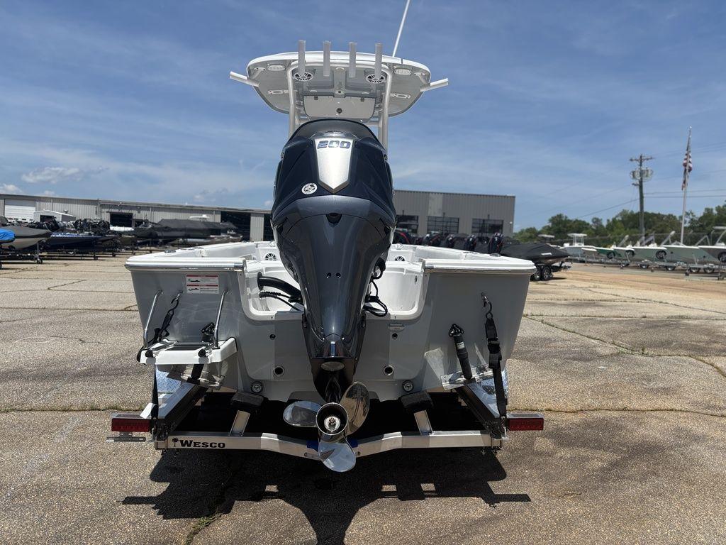 2024 Sportsman Masters 227 Bay boat on trailer, rear view in outdoor setting.