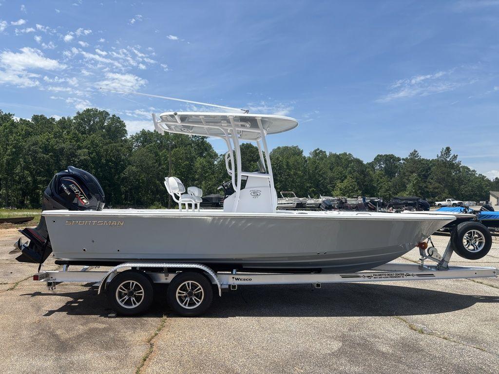 2024 Sportsman Masters 227 Bay boat on trailer, parked outdoors under clear sky.