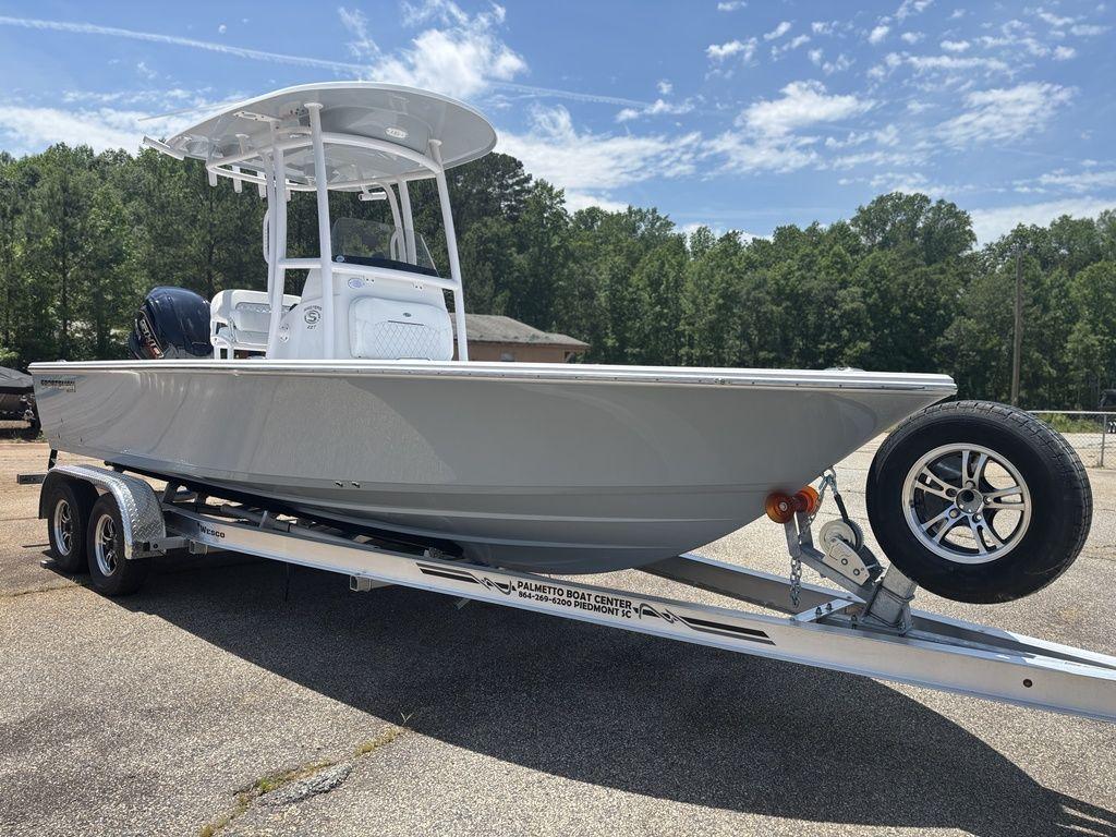 2024 Sportsman Masters 227 Bay boat on trailer, parked outdoors under clear sky.