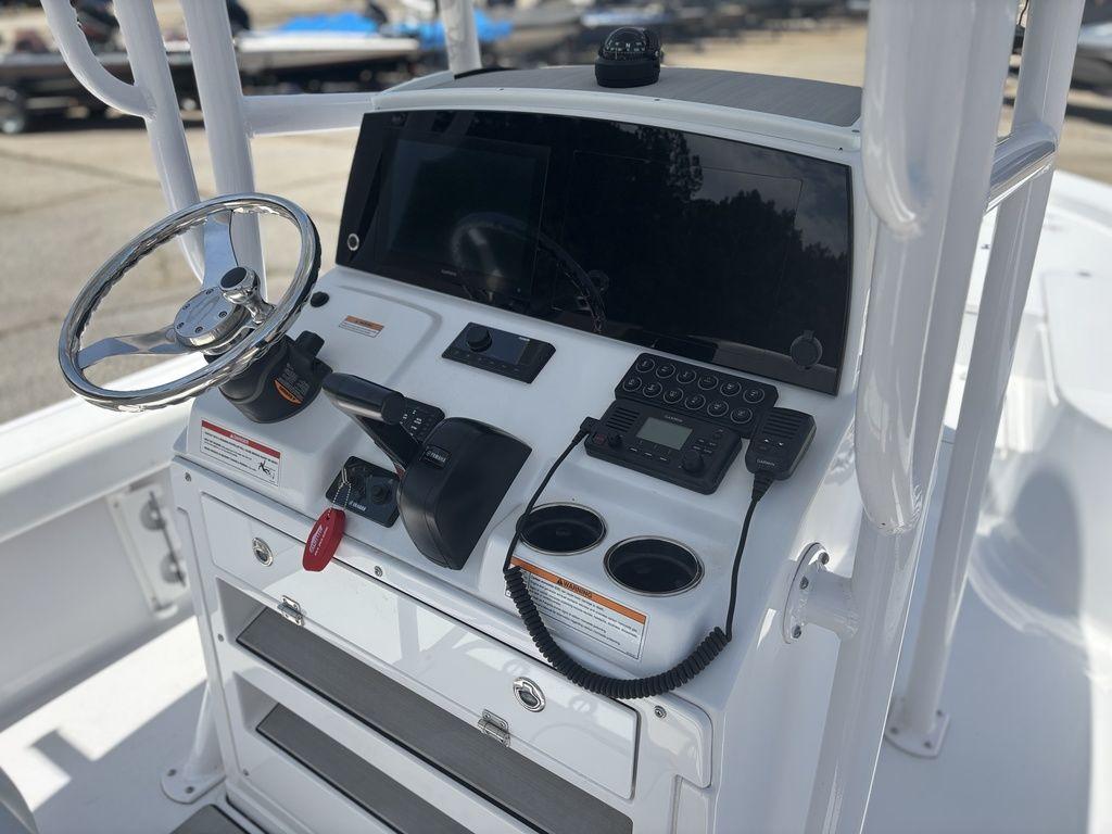 2024 Sportsman Masters 227 Bay boat console with steering wheel and navigation controls.