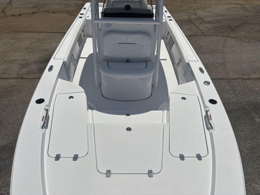 2024 Sportsman Masters 227 Bay boat deck with seating and storage compartments.