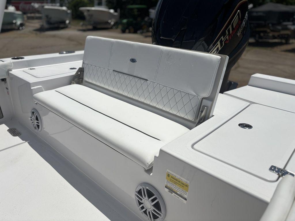 2024 Sportsman Masters 227 Bay boat with white cushioned seating and speaker system.