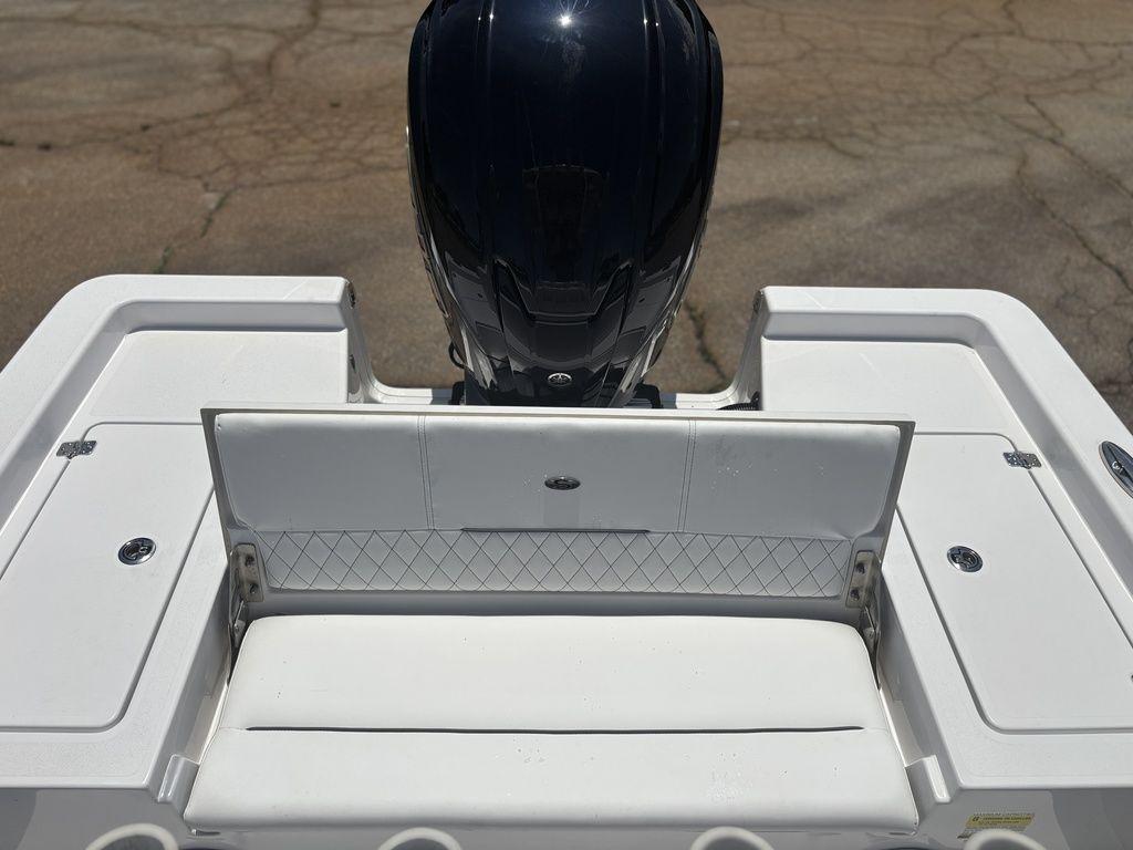 2024 Sportsman Masters 227 Bay boat with white seating and engine view.