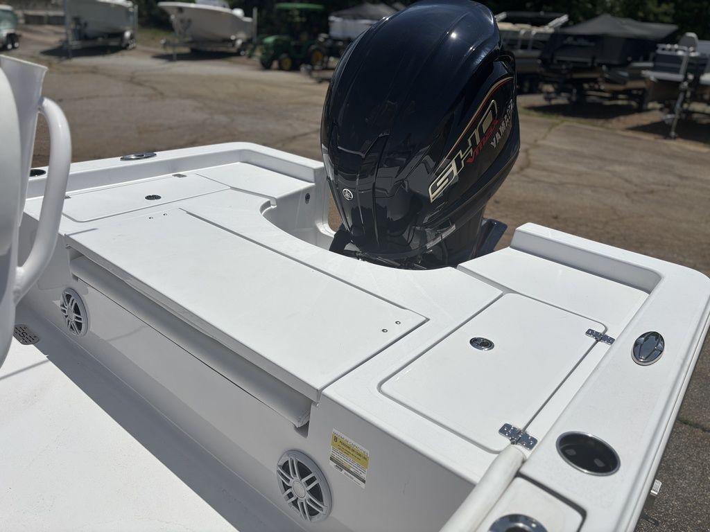 2024 Sportsman Masters 227 Bay boat with outboard motor, featuring a sleek white deck design.