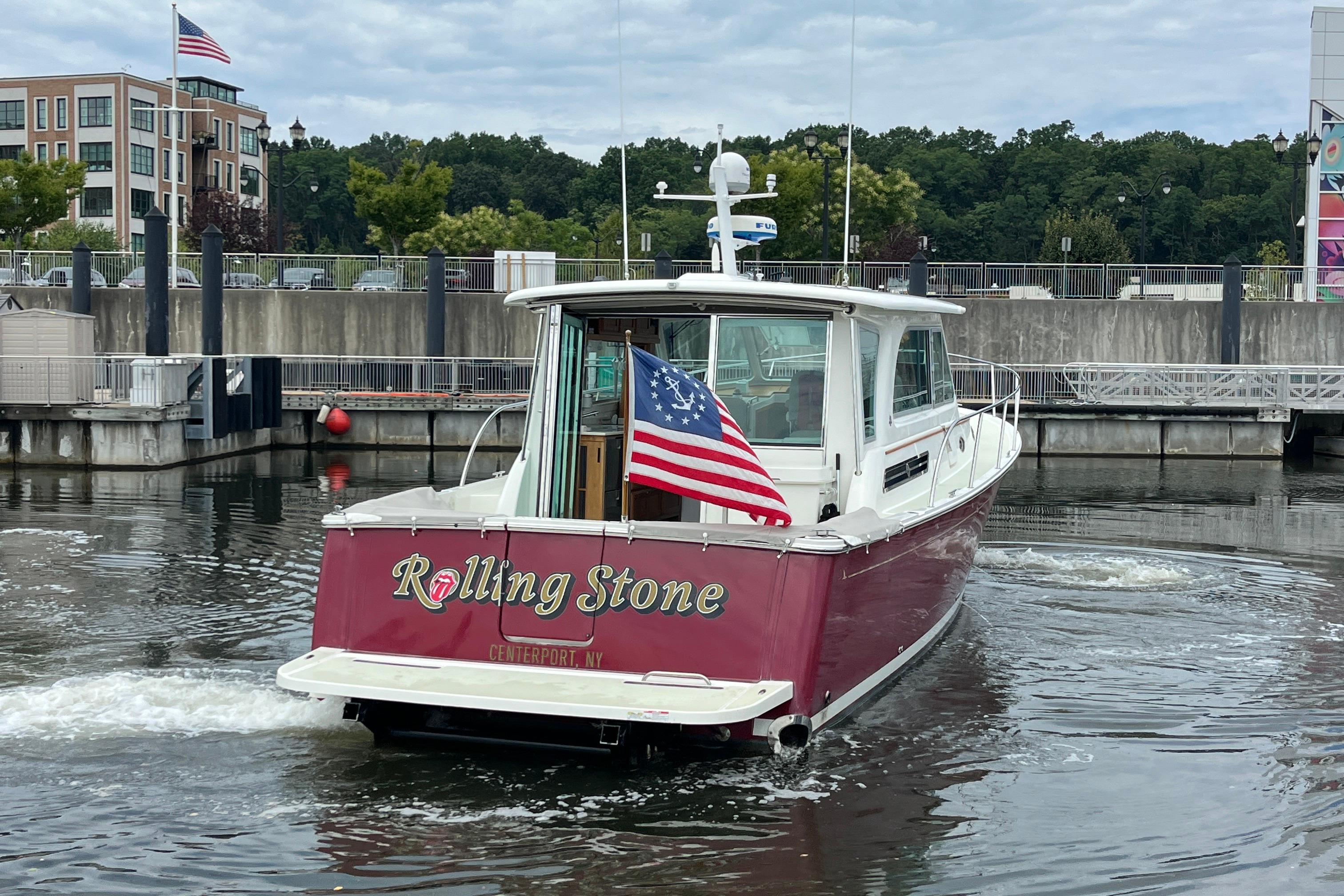 2017 Back Cove 41 boat named u0022Rolling Stoneu0022 with American flag at marina.