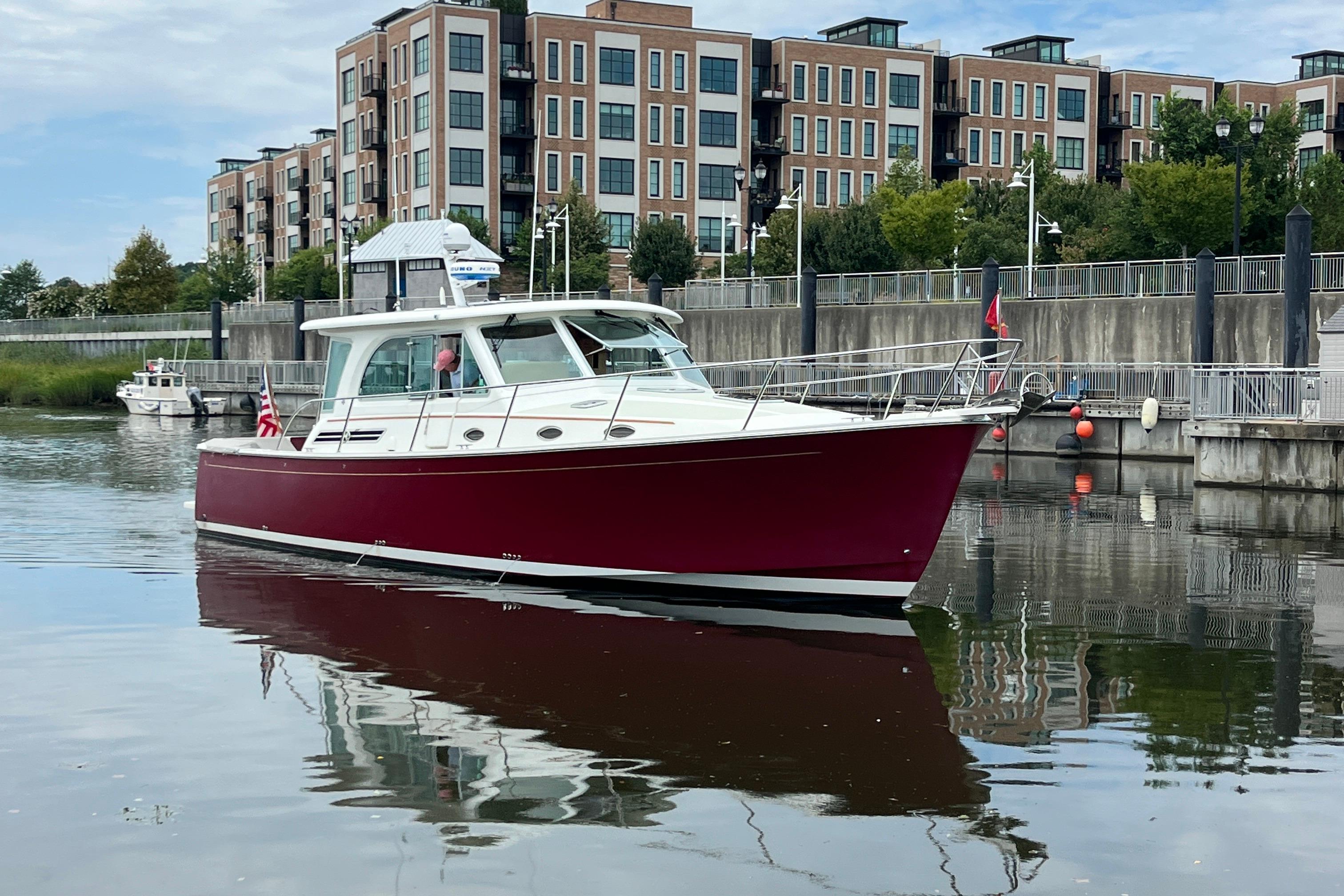 2017 Back Cove 41 boat docked near modern waterfront buildings.