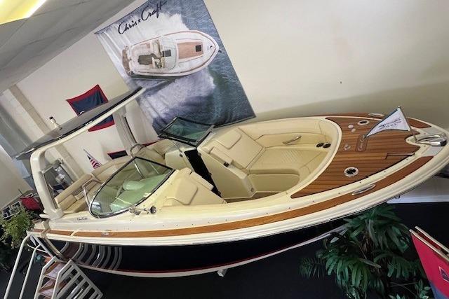 2025 Chris-Craft Launch 28 GT boat displayed indoors, featuring elegant design and luxurious seating.