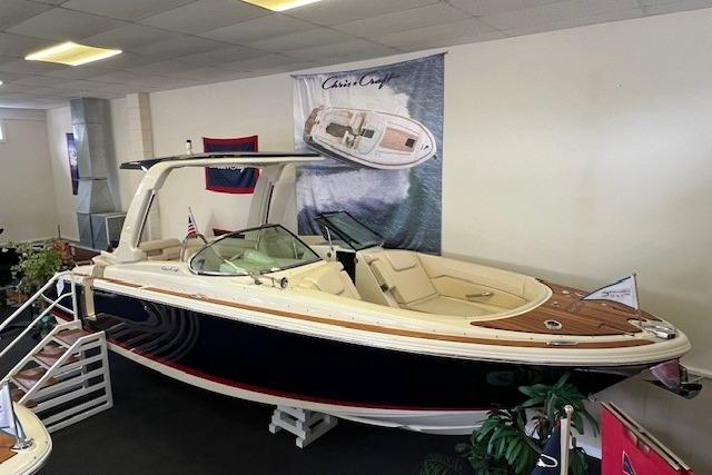 2025 Chris-Craft Launch 28 GT boat displayed indoors, featuring elegant design and luxurious seating.