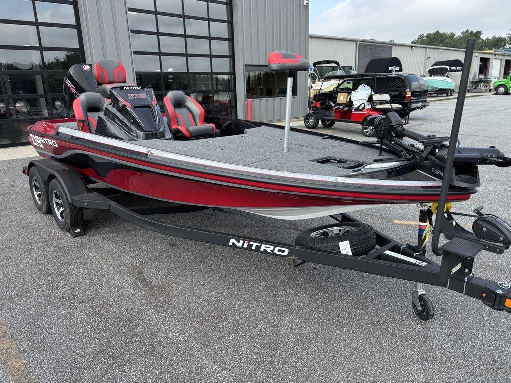 2025 Nitro Z19 Pro boat on trailer, parked outside dealership.
