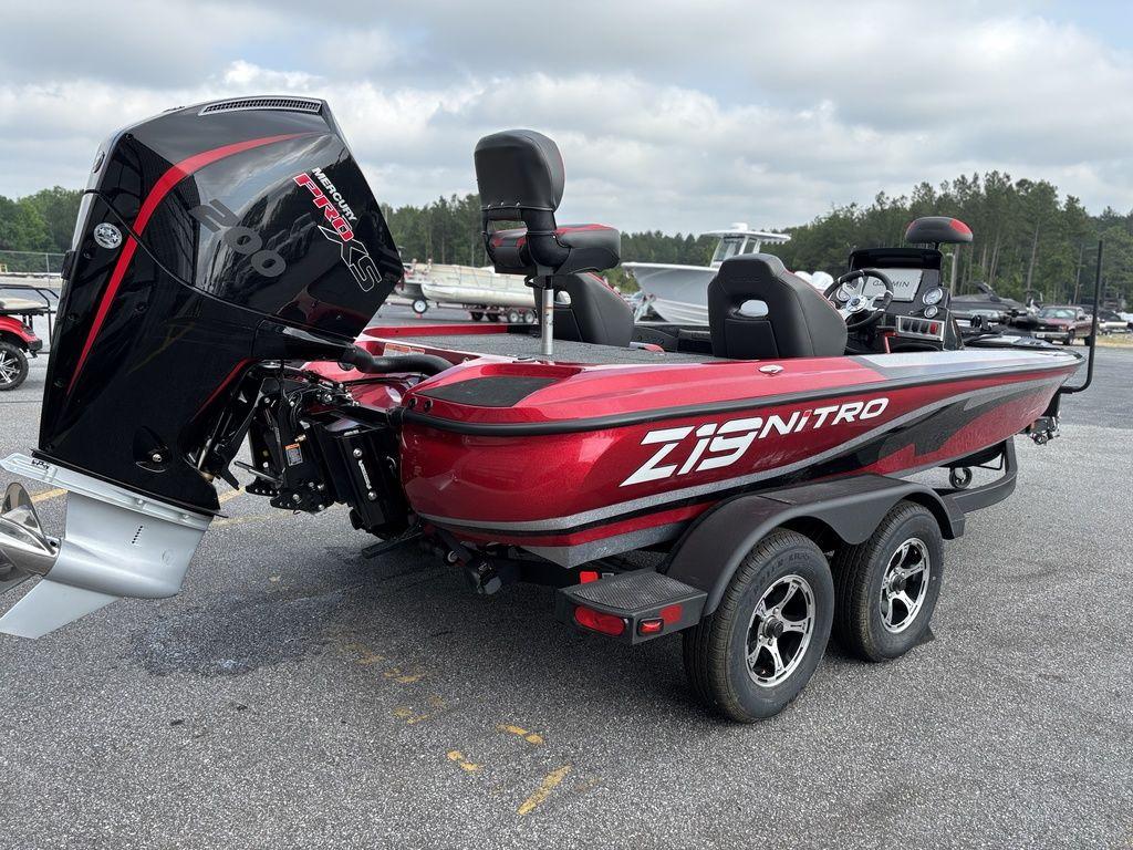 2025 Nitro Z19 Pro boat with red and black design, parked on a trailer.