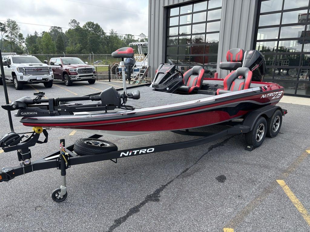 2025 Nitro Z19 Pro boat with trailer, parked outdoors near vehicles.