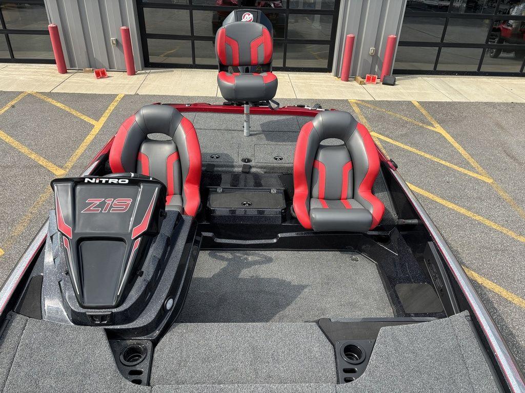 2025 Nitro Z19 Pro boat with red and gray seating, parked outdoors.