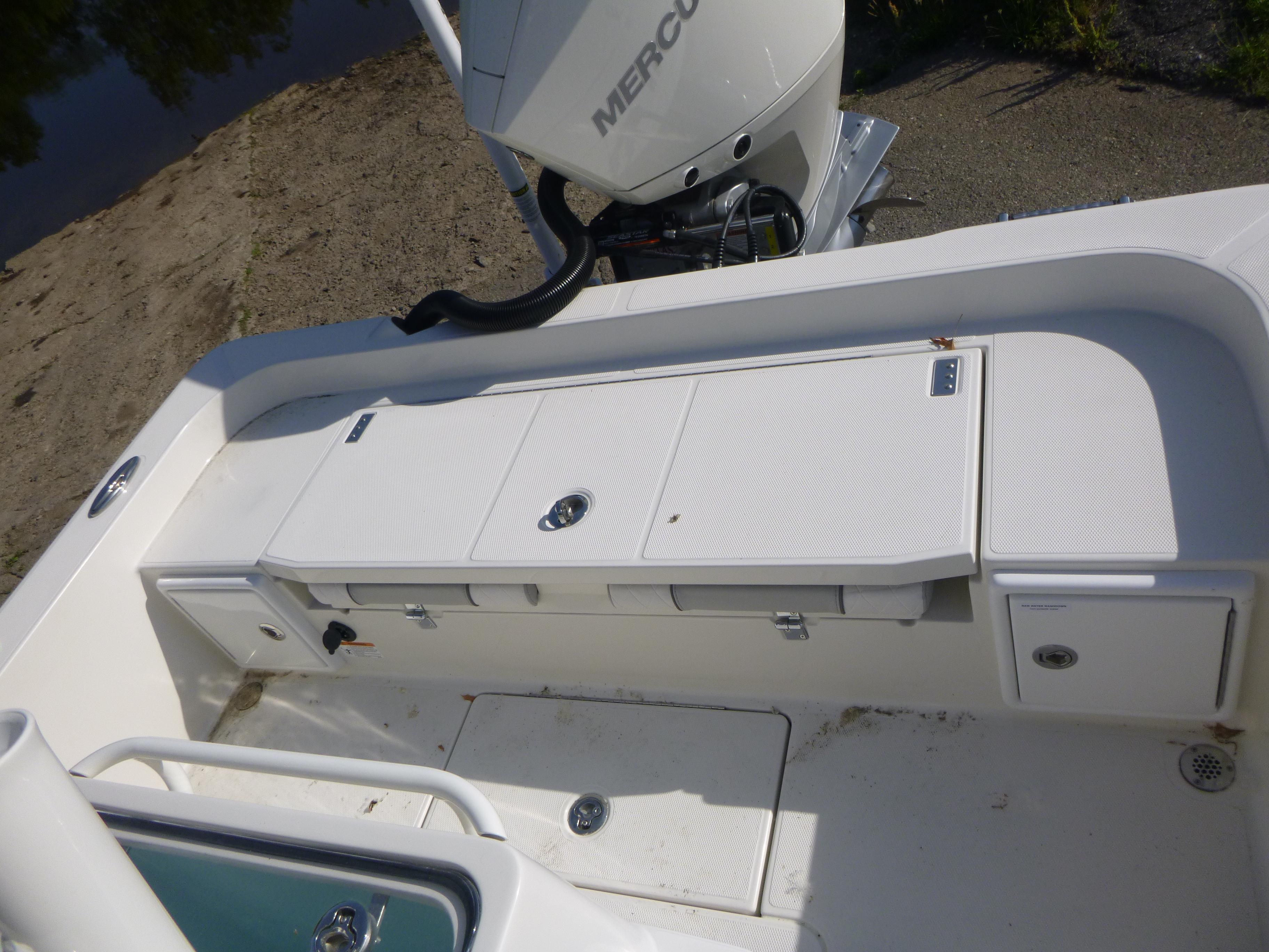 2024 Ranger 2360 Bay Ranger boat deck with storage compartments and Mercury engine.