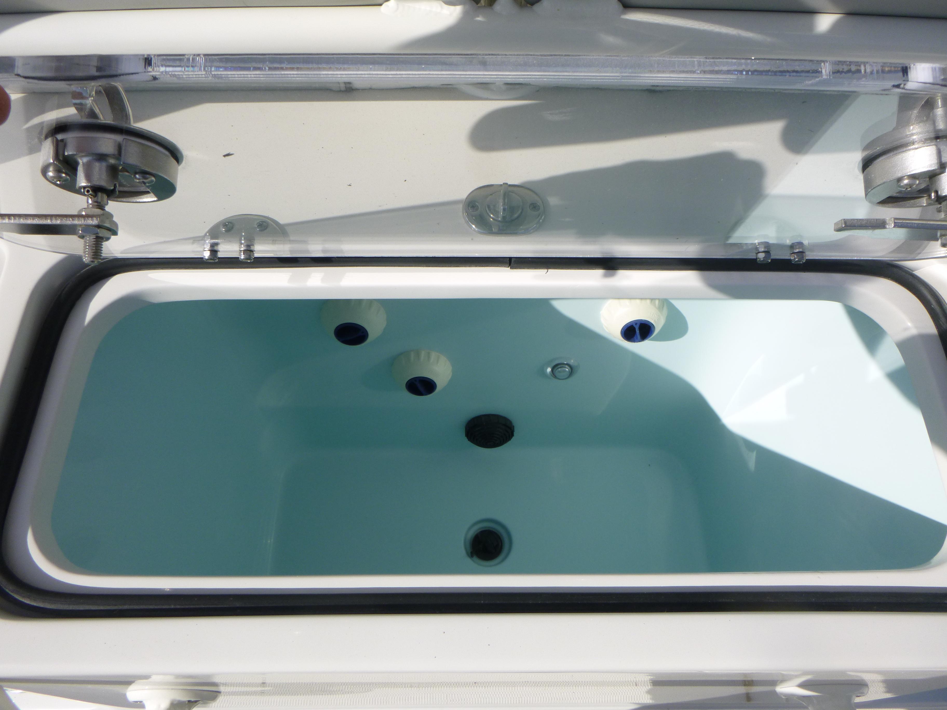 Livewell compartment of 2024 Ranger 2360 Bay Ranger boat, open lid view.