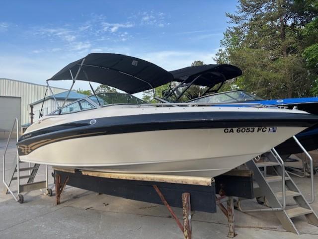 1999 Crownline 202 boat with canopy on dry dock, registration GA 6053 FC.