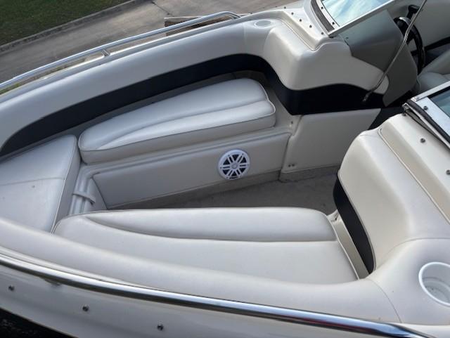 1999 Crownline 202 boat interior with white seating and speaker detail.