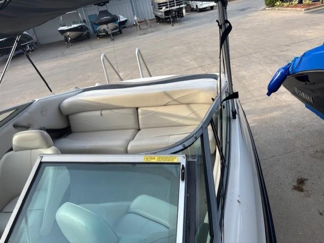 1999 Crownline 202 boat interior with white seating, docked in a marina.