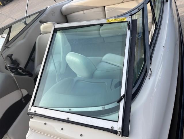 1999 Crownline 202 boat interior with windshield and seating.