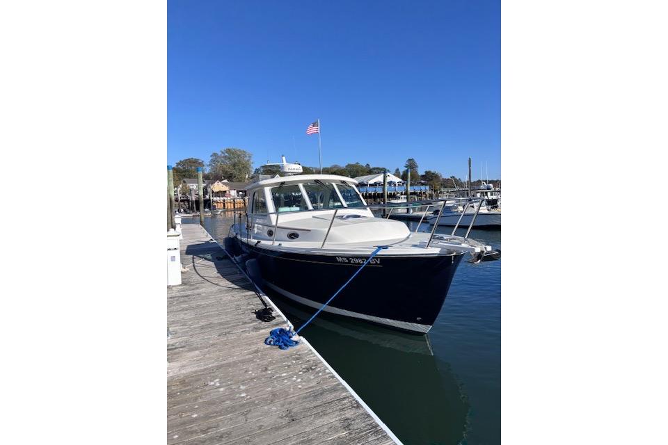 2018 Back Cove 30 boat docked at marina under clear blue sky.