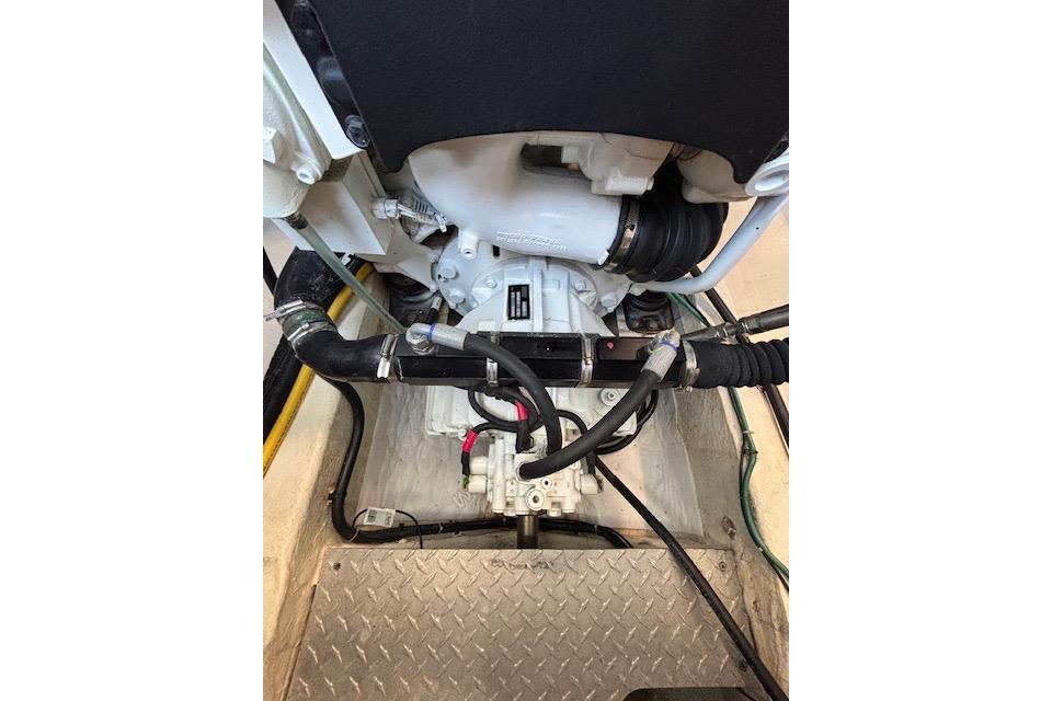 Engine compartment of a 2018 Back Cove 30 boat, showcasing mechanical components and hoses.