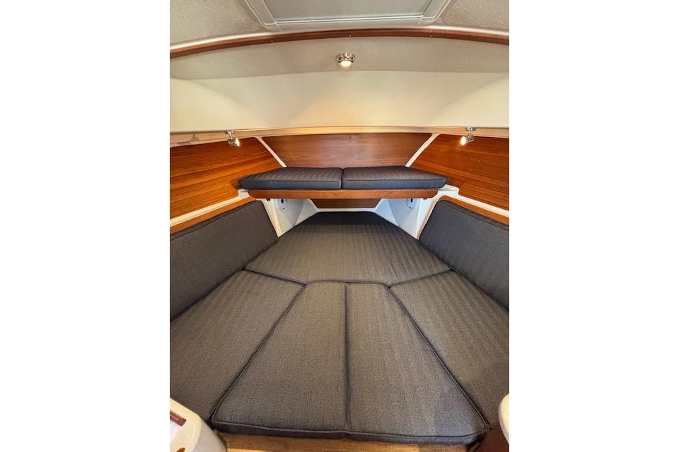 2018 Back Cove 30 interior cabin with cushioned seating and wooden accents.