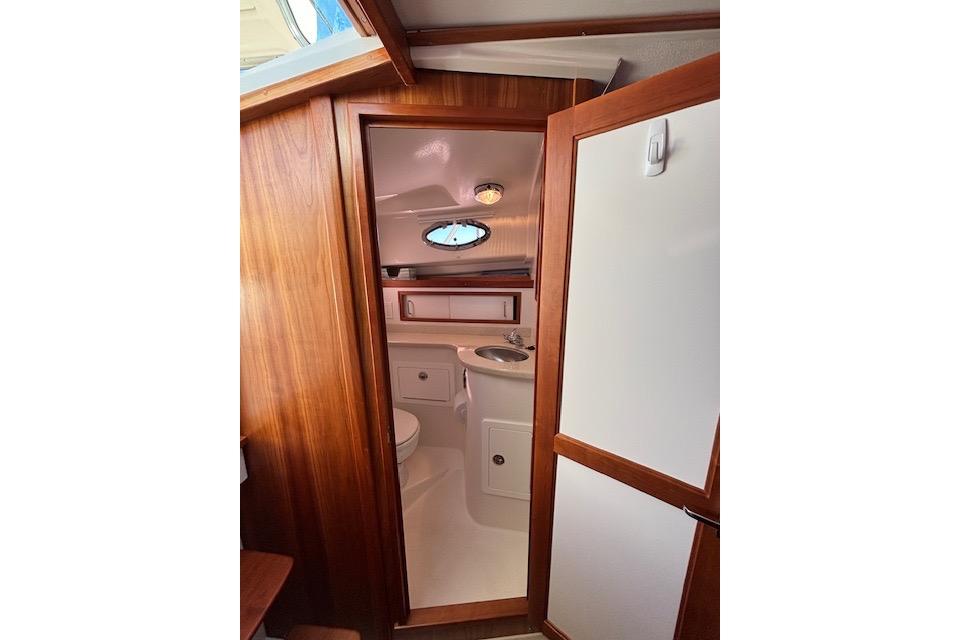 2018 Back Cove 30 yacht interior bathroom with wooden finish and compact design.