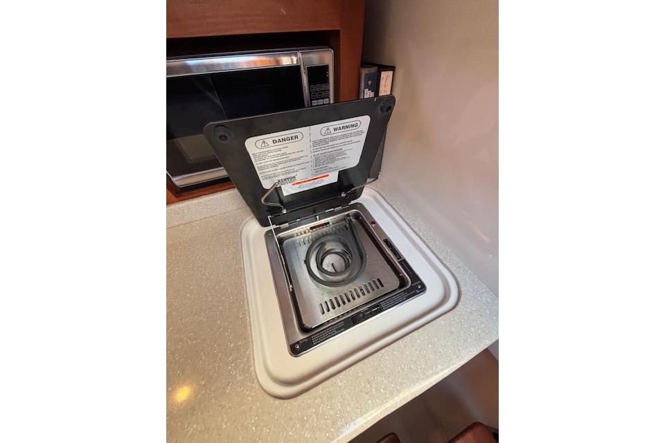 Built-in stove on 2018 Back Cove 30 yacht, with safety warnings visible.