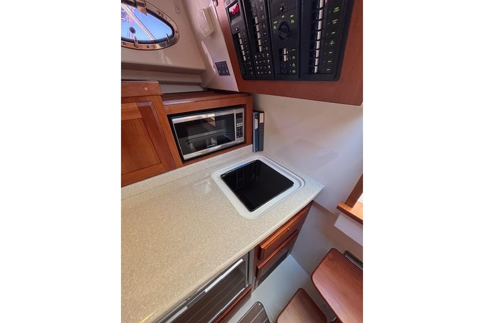 2018 Back Cove 30 yacht interior galley with microwave and control panel.