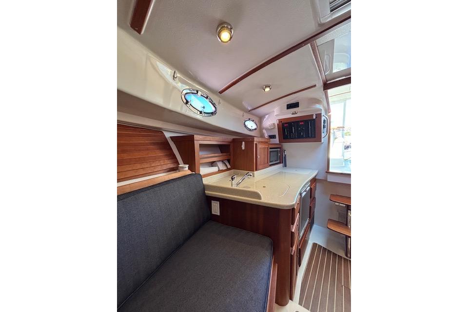 Interior of 2018 Back Cove 30 boat with modern kitchen and seating area.