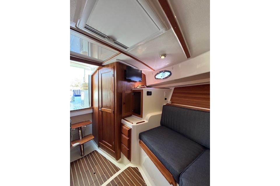 2018 Back Cove 30 interior with wood accents, seating, and storage.