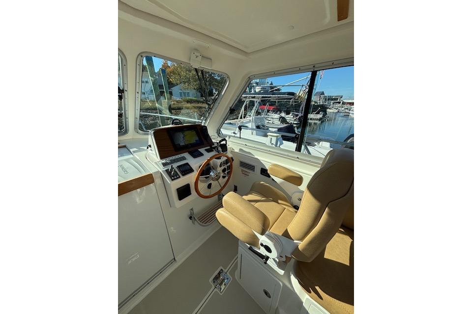 2018 Back Cove 30 boat interior with helm, steering wheel, and navigation equipment.