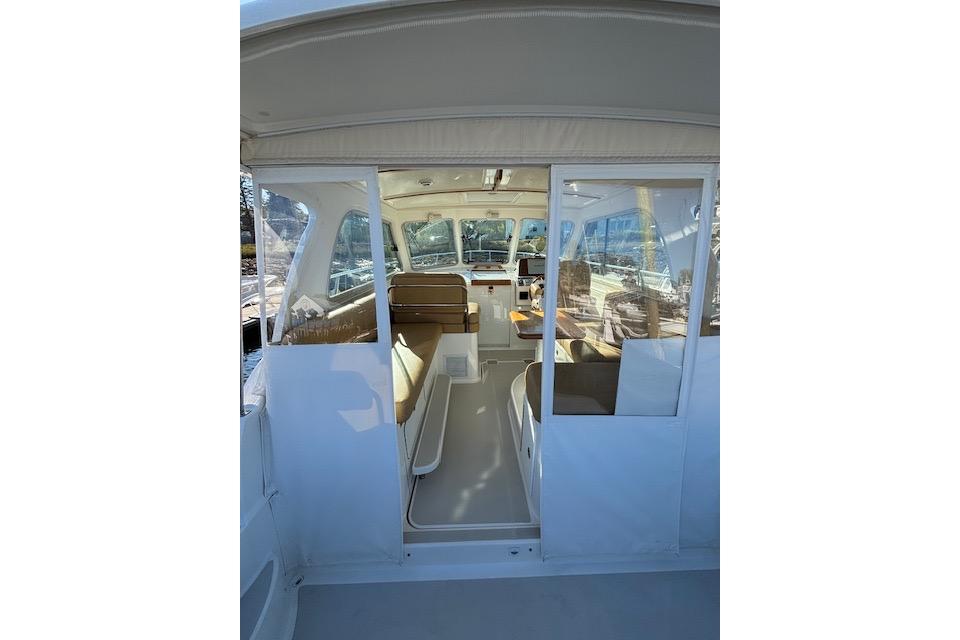 2018 Back Cove 30 boat interior with seating and helm, viewed from the entrance.