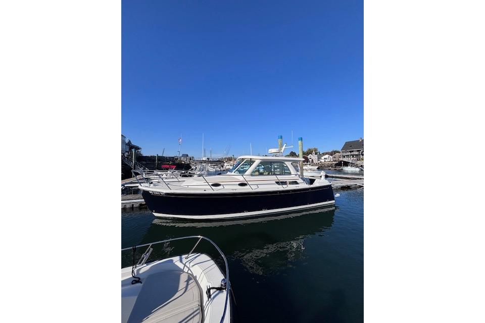 2018 Back Cove 30 boat docked in a marina under clear blue skies.
