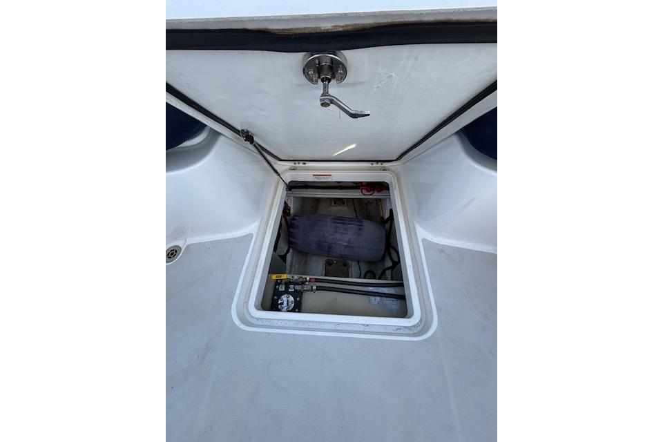 Open hatch on 2018 Back Cove 30 boat, revealing storage compartment.