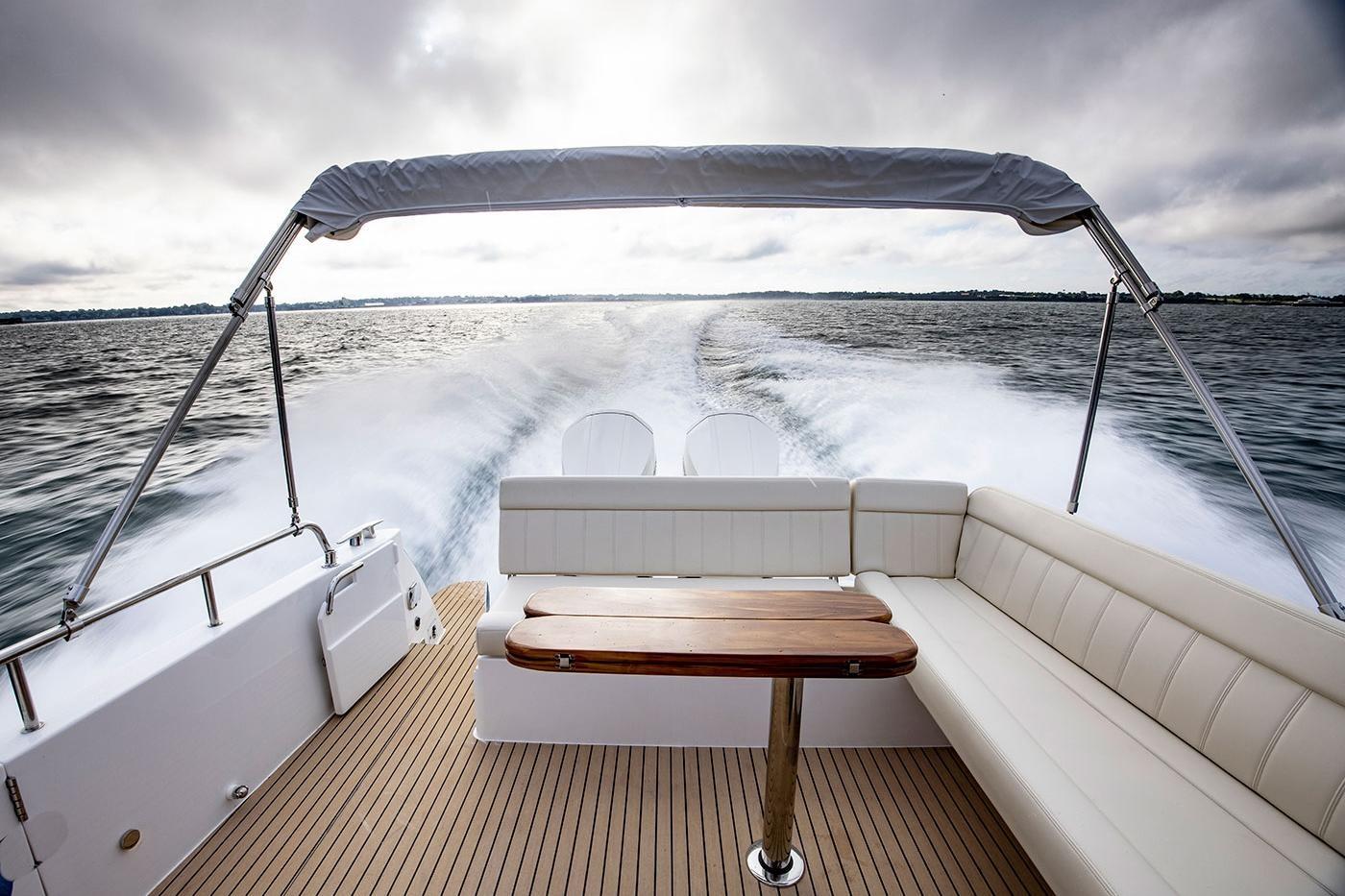 2025 MJM 4 boat cruising on water, featuring spacious seating and sleek design.