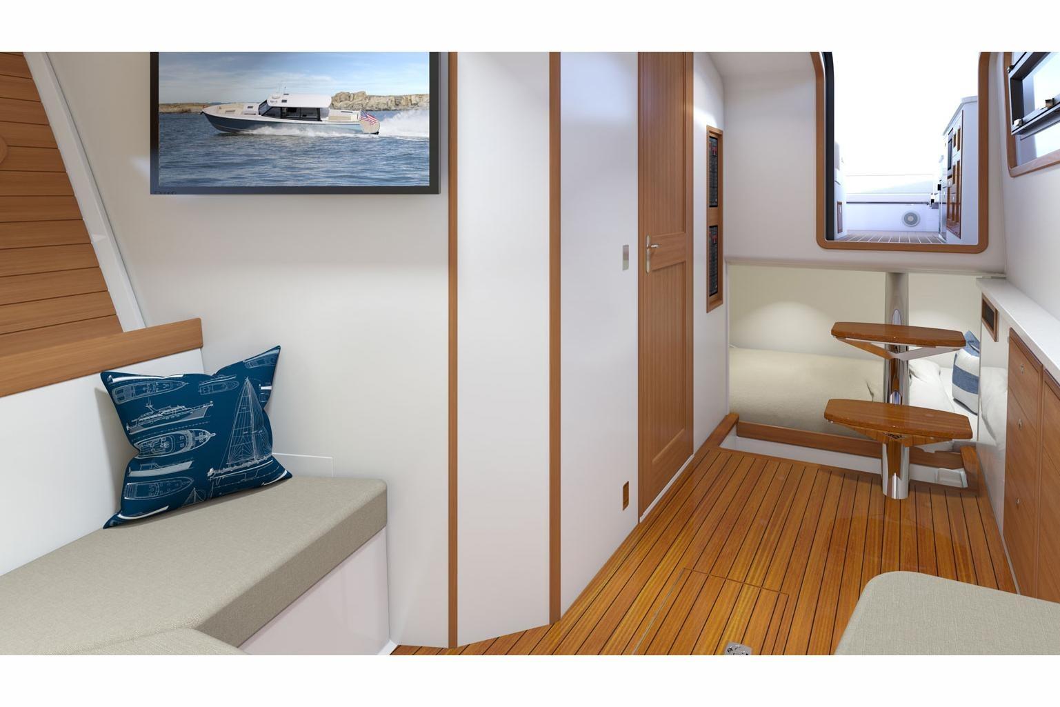 Interior of 2025 MJM 4 boat with wooden flooring and nautical decor.