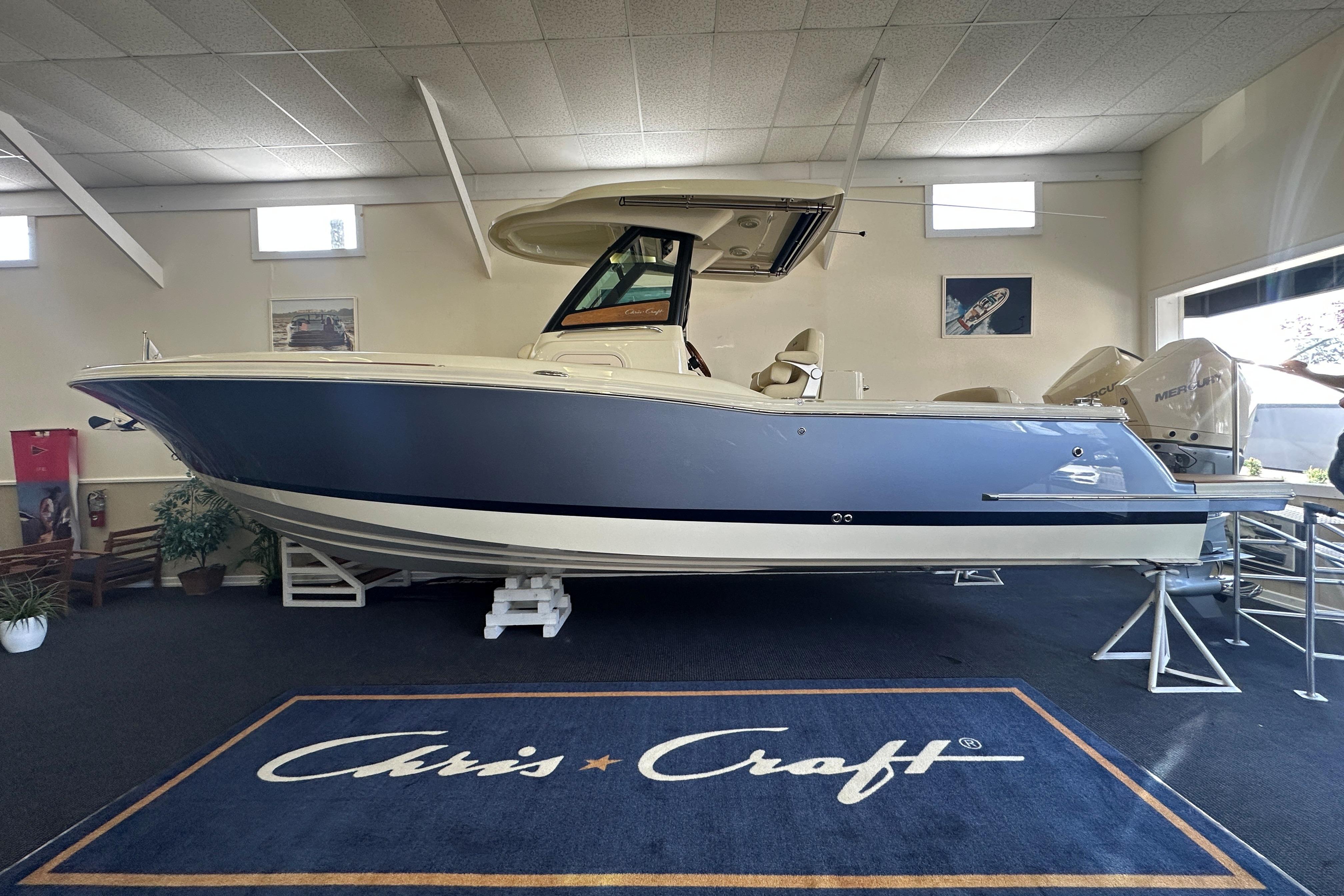 2024 Chris-Craft Catalina 28 boat displayed indoors, showcasing sleek design and modern features.