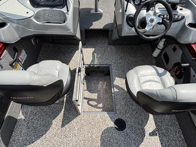 2015 Tracker Targa V-18 Combo boat interior with two seats and open storage compartment.