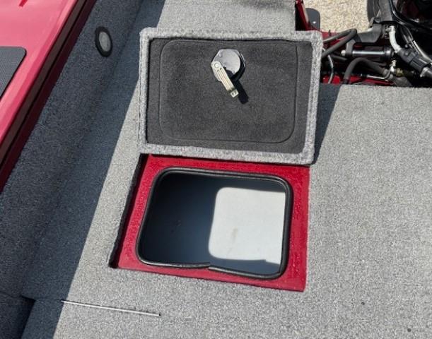 2015 Tracker Targa V-18 Combo boat storage compartment with open lid and key.